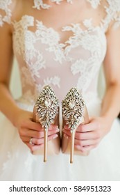 wedding shoes in brides hands