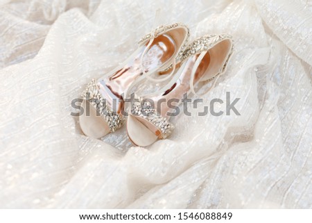 wedding shoes and wedding dress. Beautiful colorful wedding shoes for bride indoors. Beauty of bridal heel for marriage. Female couple boots for celebration