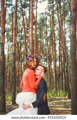 Wedding shot of bride and groom in park. Wedding couple just married with bridal bouquet.  Young couple in love outdoor.