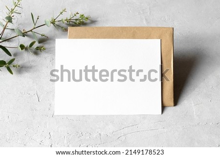 Wedding stationery invitation card mockup 5x7 on neutral grey background with envelope and eucalyptus, natural lighting, bridal shower mockup Minimal blank card mockup, thank you card, greeting card