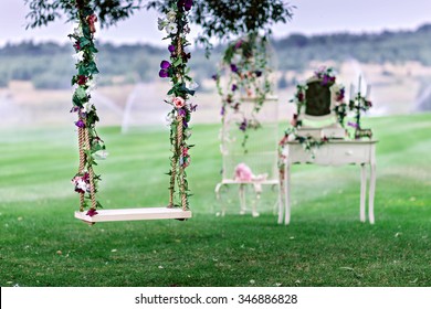 Wedding Swing Decorated With Flowers Hanging On The Branches Of The Old Willow