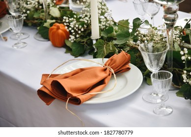 Wedding Table Decoration. Orange Napkin on Plate. Rustic Style