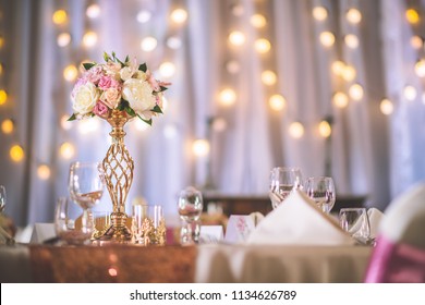 Wedding Table With Exclusive Floral Arrangement Prepared For Reception, Wedding Or Event Centerpiece In Rose Gold Color