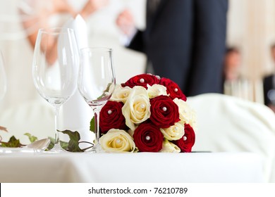 Wedding table at a wedding feast decorated with bridal bouquet