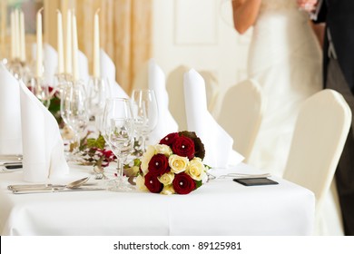 Wedding Table At A Wedding Feast Decorated With Bridal Bouquet