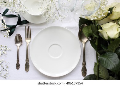 Wedding Table Mockup With White Roses. Beautiful Dishware, Antique Silver Cutlery.