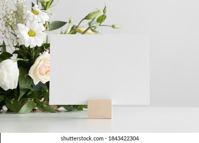 Wedding Table Number Card Mockup With A Floral Arrangement.