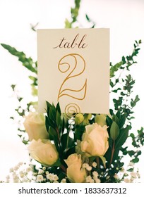 Wedding Table Number Holder With White Roses, Green Leaves And Flowers