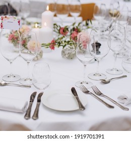 Der Hochzeitstisch im Restaurant ist mit weißen Kerzen und Blumen geschmückt.