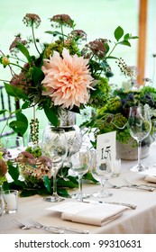 A Wedding Table Set For Fine Dining With A Pretty Flower Centerpiece