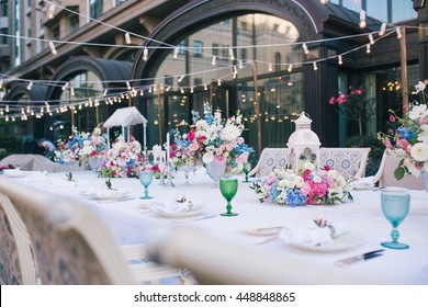 Wedding table that decorated with flower arrangements and candles