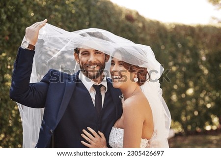 Wedding, veil and couple with love, marriage and celebration for relationship, loyalty and commitment. Portrait, bride or groom with a smile, married or cover with dress with happiness in a garden