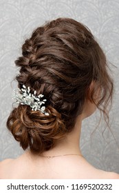 Wedding Woman's Hairdress Low Bun On Brown-haired Back View Close-up.