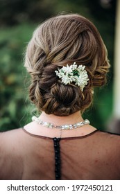 Wedding Woman's Hairdress Low Bun On Brown-haired Back View Close-up.