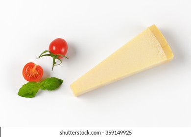 Wedge Of Fresh Parmesan Cheese And Cherry Tomatoes On White Background