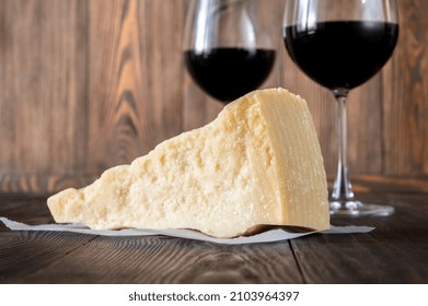 Wedge Of Parmesan Cheese On Wooden Background