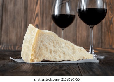 Wedge Of Parmesan Cheese On Wooden Background