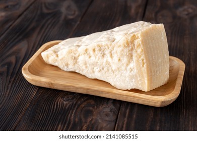 Wedge Of Parmesan Cheese On Wooden Background