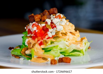 Wedge Salad. Classic American Salad With Iceberg Lettuce, Blue Cheese Dressing, Red Onions, Bacon Lardons, Parmesan Cheese, Olive Oil, Lemon Juice, Salt And Pepper. A Fine Dining Restaurant Classic.