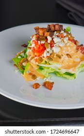 Wedge Salad. Classic American Salad With Iceberg Lettuce, Blue Cheese Dressing, Red Onions, Bacon Lardons, Parmesan Cheese, Olive Oil, Lemon Juice, Salt And Pepper. A Fine Dining Restaurant Classic.