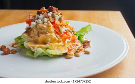 Wedge Salad. Classic American Salad With Iceberg Lettuce, Blue Cheese Dressing, Red Onions, Bacon Lardons, Parmesan Cheese, Olive Oil, Lemon Juice, Salt And Pepper. A Fine Dining Restaurant Classic.