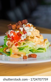 Wedge Salad. Classic American Salad With Iceberg Lettuce, Blue Cheese Dressing, Red Onions, Bacon Lardons, Parmesan Cheese, Olive Oil, Lemon Juice, Salt And Pepper. A Fine Dining Restaurant Classic.