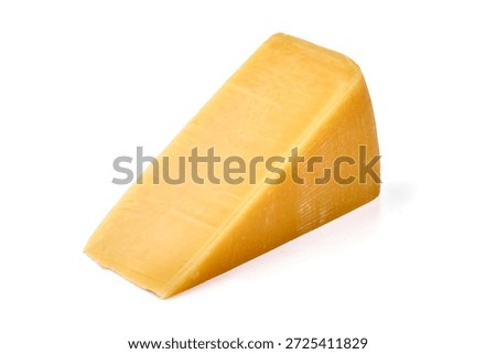 Wedge of sharp cheddar cheese with a smooth, glossy surface, isolated on white background