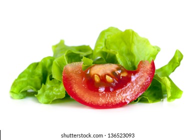 Wedge Of Tomato With Curly Leaf Lettuce, Isolated On White Background.