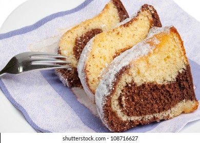 Wedges Of Marbel Cake On A Plate With Fork