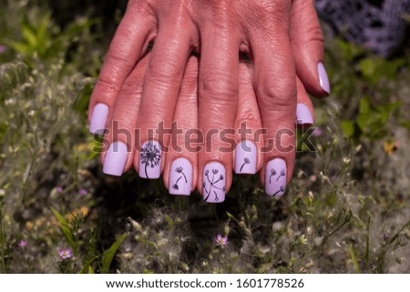 Weeds and dandelions on purple nails