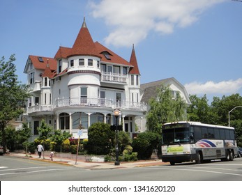 Weehawken, NJ - June 9 2013: A NJ Transit Coach Bus At A Bus Stop Next To A Victorian House On Boulevard East