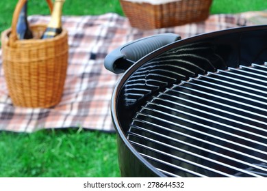 Weekend Barbecue Picnic Scene With Wine In Basket And Grill