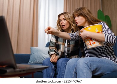 Weekend Entertainment. Two Women Watching Movie On Laptop Sitting On Couch In Home