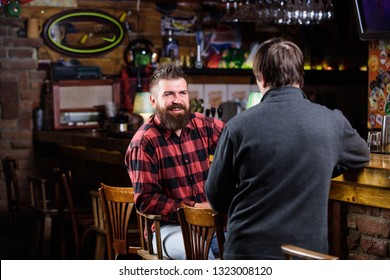 Weekend Leisure. Friday Relaxation In Pub. Friends Relaxing In Pub. Friendly Conversation With Stranger. Hipster Brutal Bearded Man Spend Leisure With Friend Bar Counter In Pub. Men Relaxing In Pub.