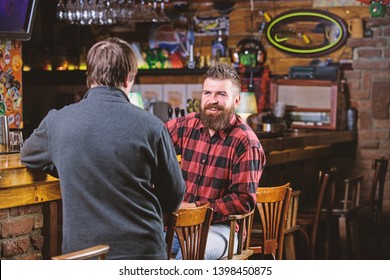 Weekend Leisure. Friday Relaxation In Pub. Friends Relaxing In Pub. Friendly Conversation With Stranger. Hipster Brutal Bearded Man Spend Leisure With Friend Bar Counter In Pub. Men Relaxing In Pub.