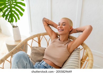 Weekend Recreation. Young Lady Sitting In Cozy Modern Chair With Eyes Closed, Resting And Relaxing At Home. Happy Woman Enjoying Free Time, Taking Break From Work