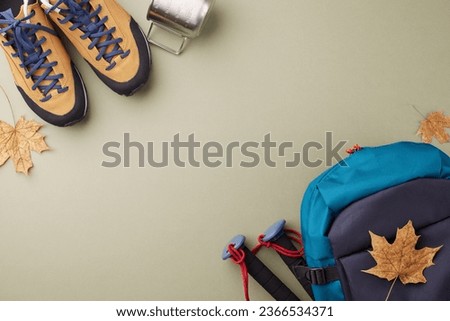 Weekend retreat surrounded by nature. Top view photo of metal cup, hiking shoes, backpack, trekking sticks, autumn leaves on green background with ad placement