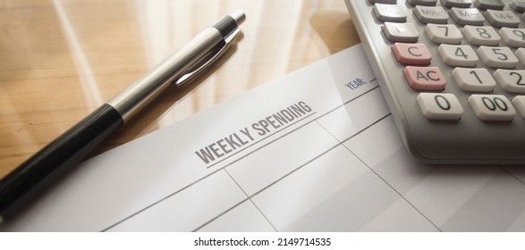 Weekly Expense Sheet Printed On The Table. Calculator , Pen And Weekly Spending On The Desk.