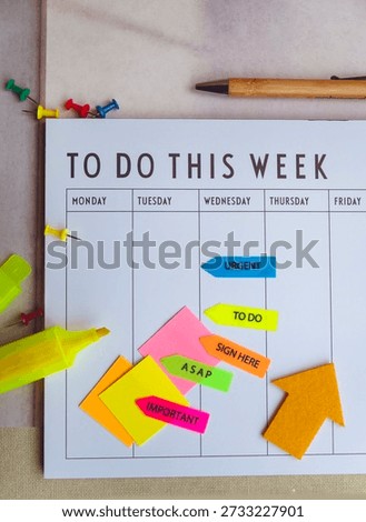 Weekly Planner with sticky notes and yellow marker