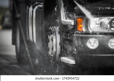 Weekly Truck Maintenance. Detailed Cleaning Semi Truck Using Pressure Washer. Close Up Photo. Transportation Industry Theme.