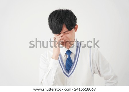 Weeping Asian high school boy in white background