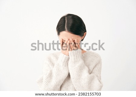 Weeping Asian middle aged woman in white background