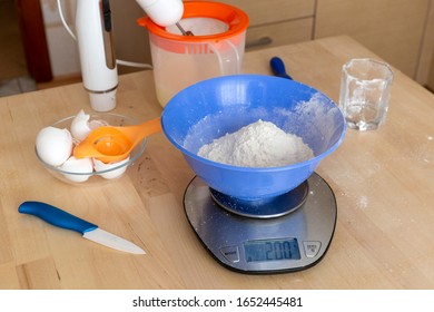 Weigh Flour And Cacao In A Bowl On A Kitchen Scale