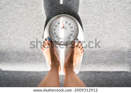 Weighing Scale Weight Check And Measure. Lady Standing After Workout
