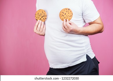 Weight Gain, Hormonal Imbalance, Eating Junk Food. Obese Man With Chocolate Cookies.