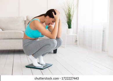 Weight Gain. Unhappy Woman Crying Standing On Weight-Scales Not Losing Weight On Diet Slimming At Home. Free Space - Shutterstock ID 1722227443