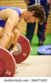 A weight lifter lifting weights during a competition