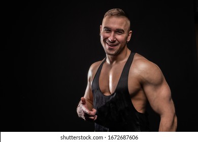 Weight Lifter Pointing Finger And Smiling On Black Background In A Black Shirt