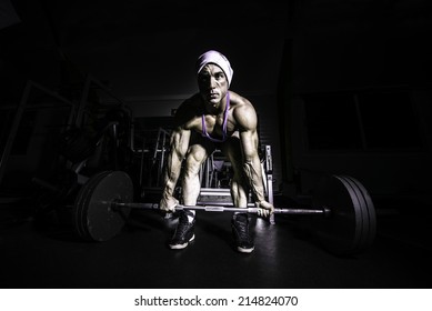 Weight Lifter - Young Man Preparing To Lift Barbell. Man Preparing To Do Dead Lift