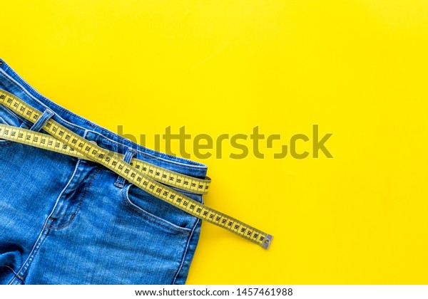 Download Weight Loss Concept Jeans Measuring Tape Stock Photo Edit Now 1457461988